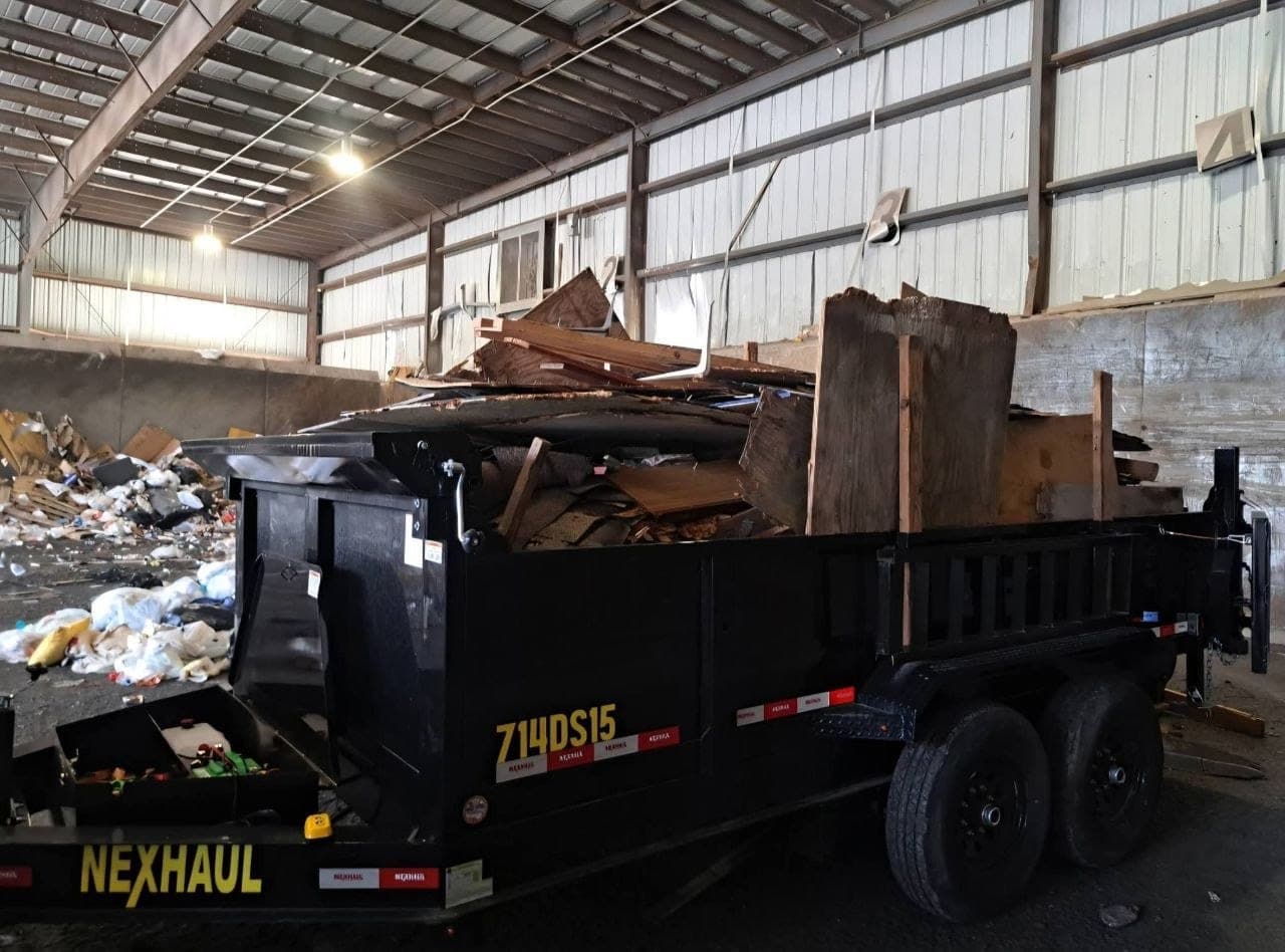 Dump trailer full of demolition timber and roofing at the transfer station